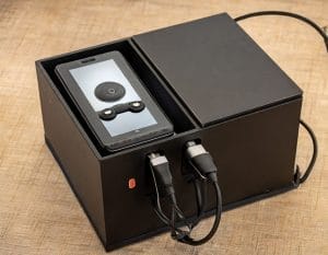 Image showing concept of an electronic device packaged in a repurposed box that becomes a charging station